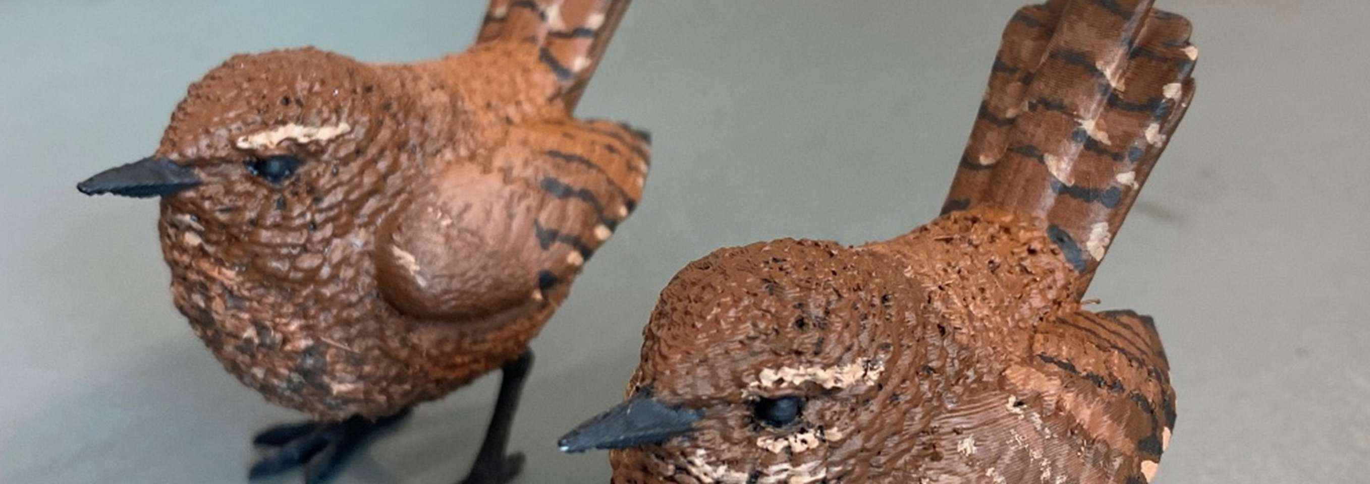 Close-up of painted wren models